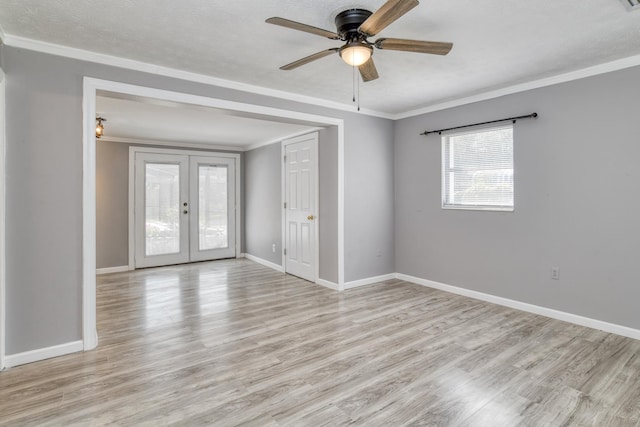 spare room featuring french doors, light hardwood / wood-style floors, ceiling fan, and ornamental molding