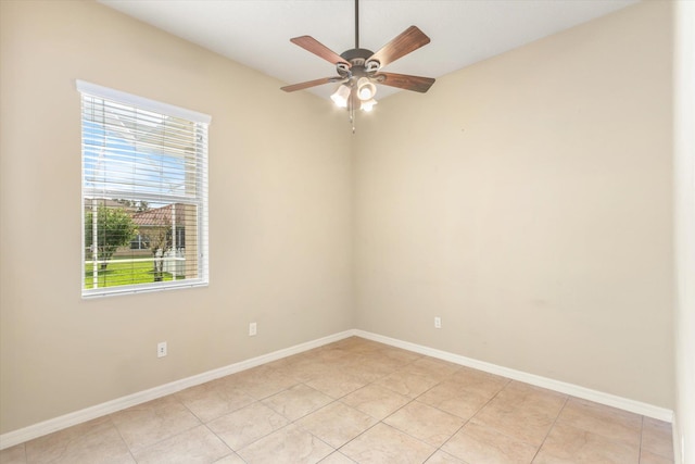 tiled empty room with a wealth of natural light and ceiling fan