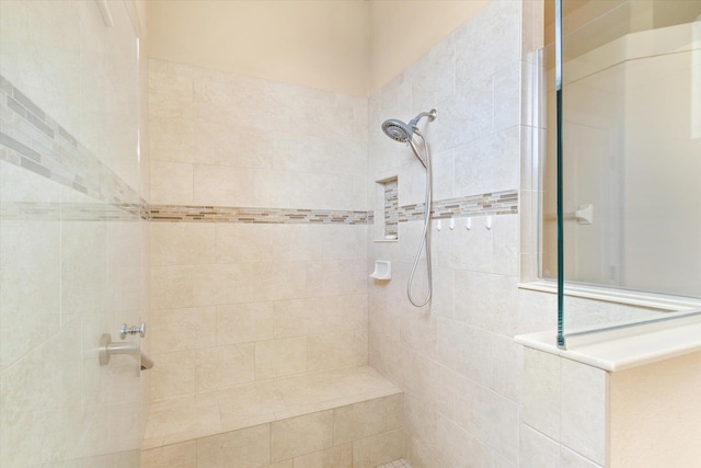 bathroom with tiled shower