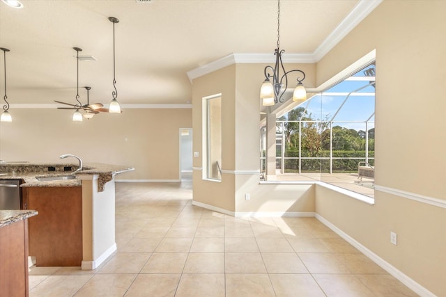 kitchen featuring sink, pendant lighting, and ornamental molding