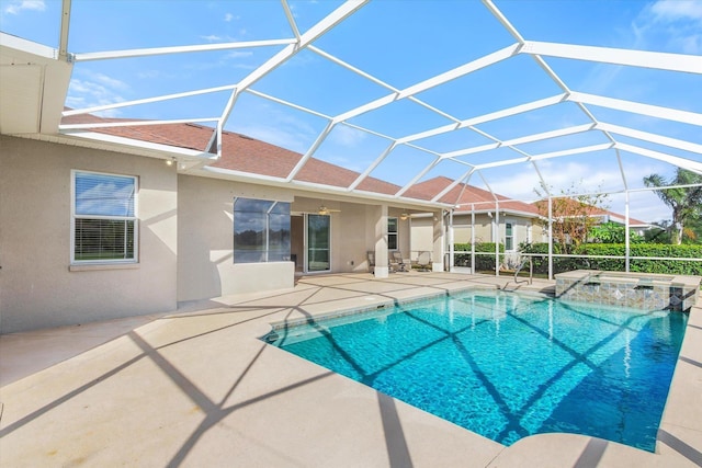 view of pool featuring a lanai, an in ground hot tub, ceiling fan, and a patio