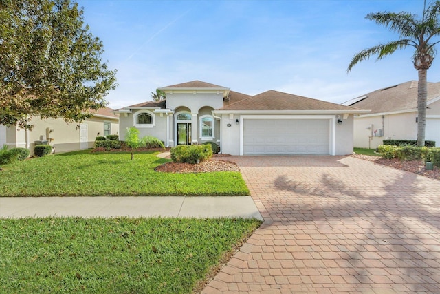 view of front of home featuring a front yard and a garage