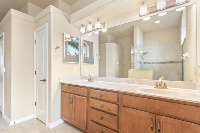 bathroom featuring tile patterned floors, vanity, and a tile shower