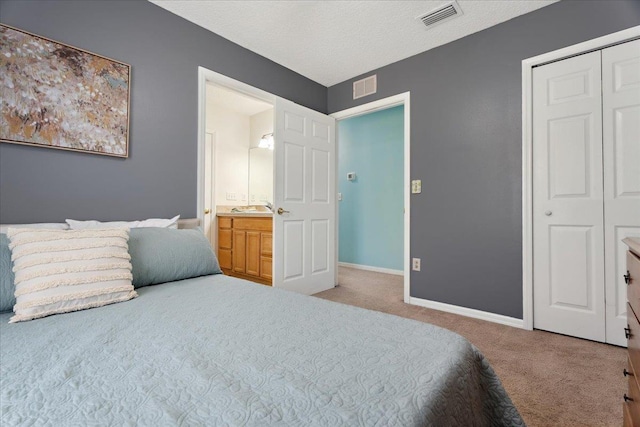 carpeted bedroom with baseboards, visible vents, a closet, and a textured ceiling