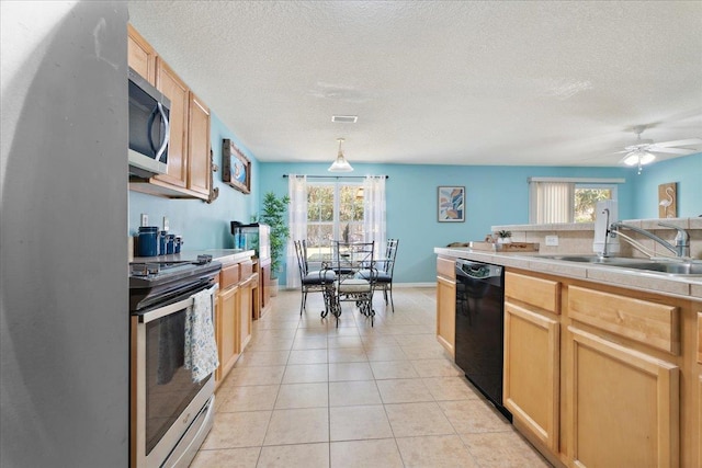 kitchen with light tile patterned floors, visible vents, light countertops, appliances with stainless steel finishes, and a textured ceiling