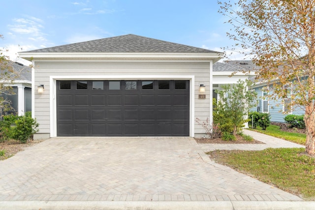 garage featuring decorative driveway