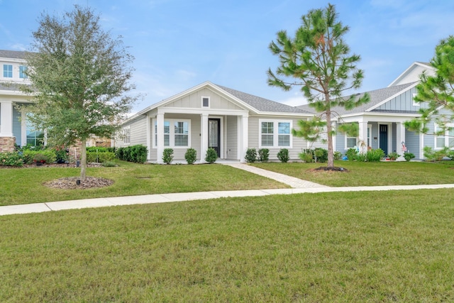 craftsman inspired home with a front lawn