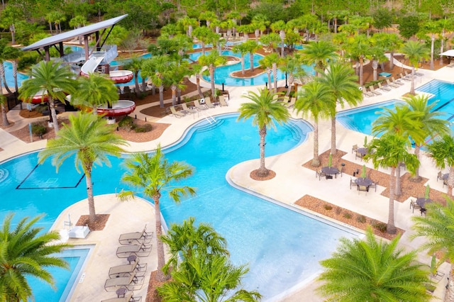 pool featuring a patio area and a water play area