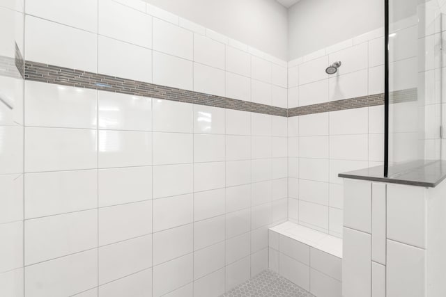 bathroom with tiled shower