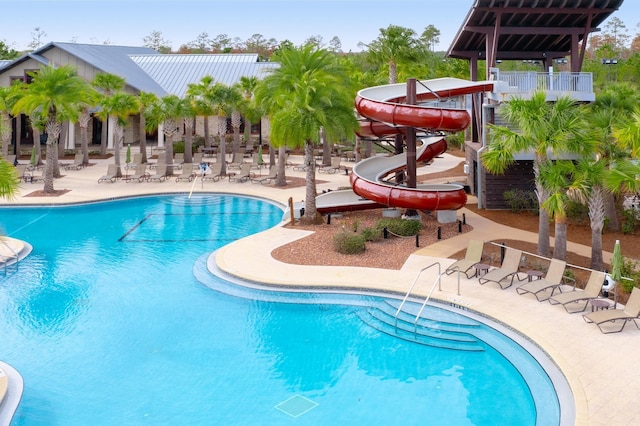 view of pool with a patio area and a water slide