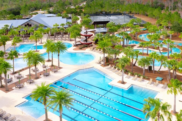 view of pool featuring a water slide and a patio