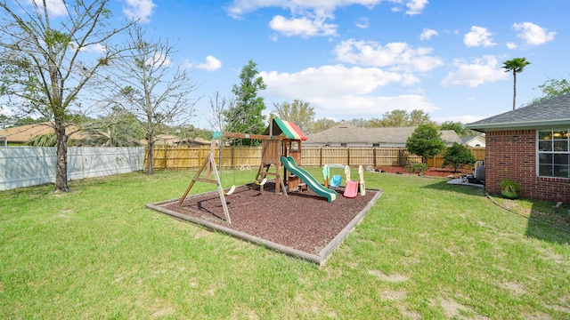 view of playground featuring a yard and a fenced backyard