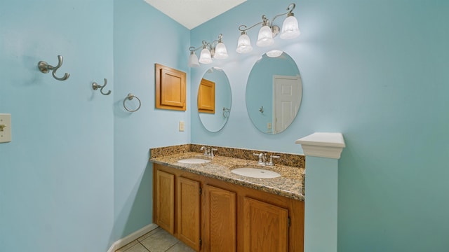 bathroom with tile patterned floors, double vanity, and a sink