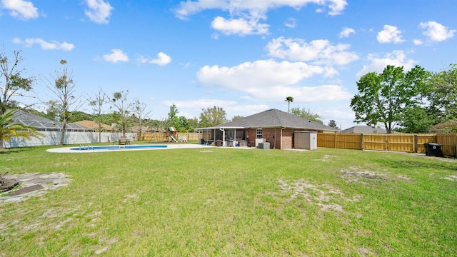 view of yard with a fenced backyard, a fenced in pool, and a patio area
