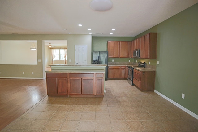 312 Brantley Harbor Dr, Saint Augustine, FL 32086 - kitchen featuring baseboards, recessed lighting, light countertops, brown cabinets, and stainless steel appliances