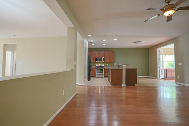 312 Brantley Harbor Dr, Saint Augustine, FL 32086 - unfurnished living room with a sink, light wood finished floors, recessed lighting, baseboards, and a ceiling fan