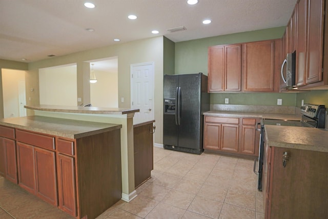 312 Brantley Harbor Dr, Saint Augustine, FL 32086 - kitchen featuring brown cabinetry, stainless steel appliances, recessed lighting, light tile patterned floors, and visible vents