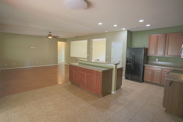 312 Brantley Harbor Dr, Saint Augustine, FL 32086 - kitchen with a kitchen island, ceiling fan, recessed lighting, brown cabinets, and black fridge