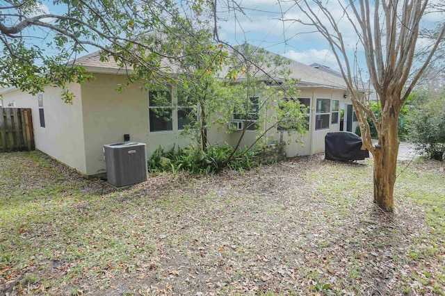 312 Brantley Harbor Dr, Saint Augustine, FL 32086 - back of property with central AC, fence, roof with shingles, and stucco siding