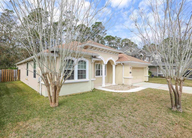 312 Brantley Harbor Dr, Saint Augustine, FL 32086 - mediterranean / spanish-style home with a garage, fence, a front yard, stucco siding, and concrete driveway