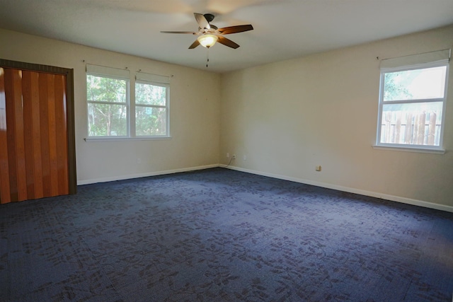312 Brantley Harbor Dr, Saint Augustine, FL 32086 - empty room featuring a healthy amount of sunlight, baseboards, ceiling fan, and dark colored carpet