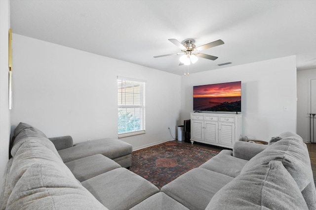 living room featuring dark hardwood / wood-style floors and ceiling fan