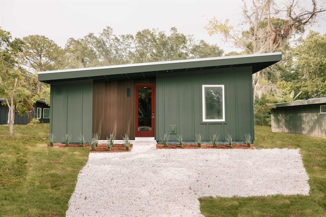 view of front of house with an outbuilding and a front yard