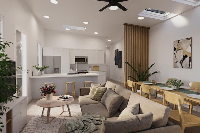 living room with ceiling fan and vaulted ceiling