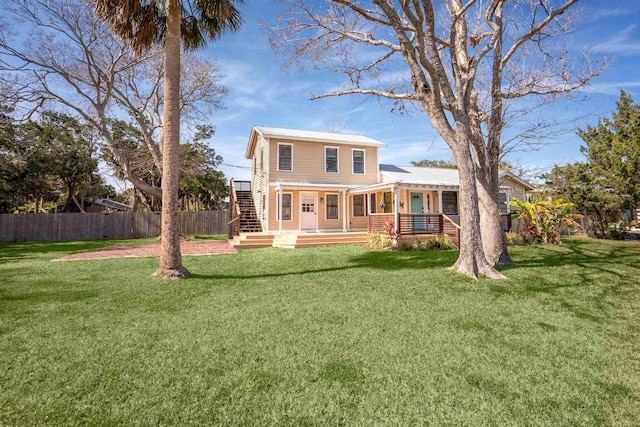 rear view of house with a lawn and a deck