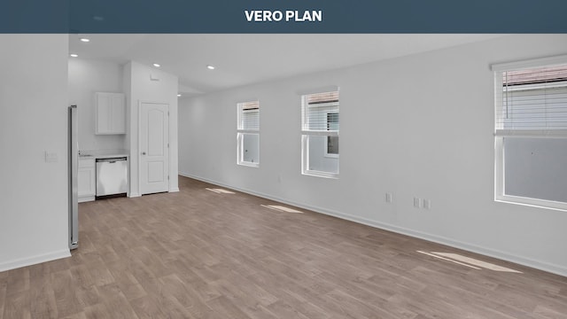 unfurnished living room featuring light hardwood / wood-style flooring and lofted ceiling