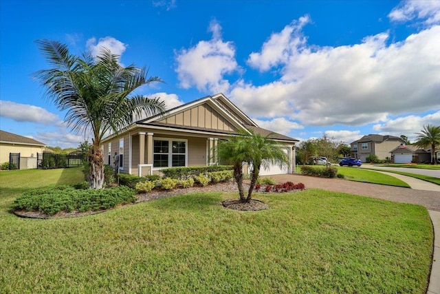 view of front of property featuring a garage and a front lawn