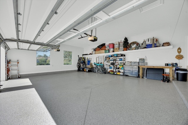 garage with a garage door opener and baseboards