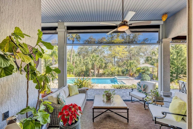 sunroom / solarium featuring plenty of natural light, wooden ceiling, and a ceiling fan