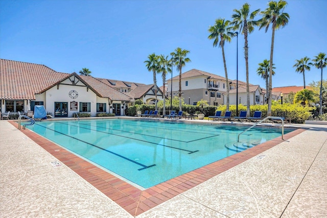 pool featuring a residential view and a patio area