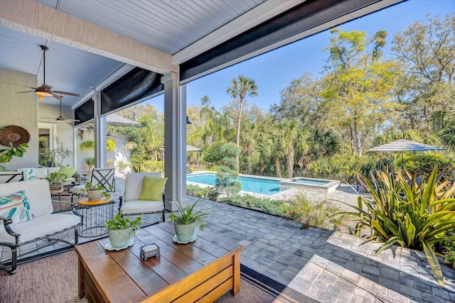 view of patio / terrace featuring an outdoor living space, ceiling fan, and a pool with connected hot tub