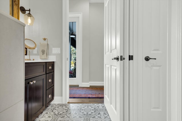 bathroom with tile patterned floors, vanity, and baseboards