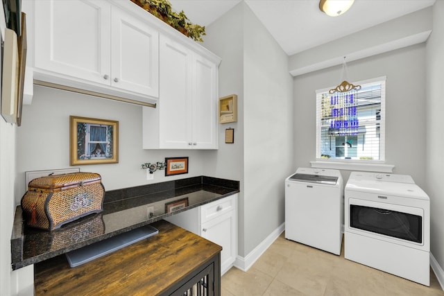 clothes washing area featuring light tile patterned floors, baseboards, cabinet space, and washer and clothes dryer