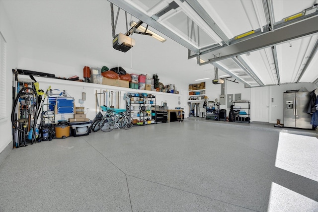 garage featuring stainless steel fridge and a garage door opener