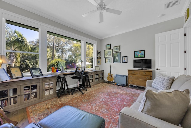 office featuring visible vents, baseboards, crown molding, and ceiling fan