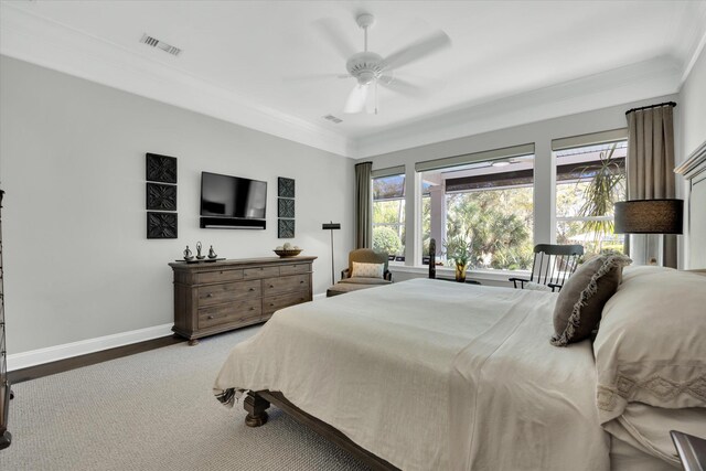 bedroom featuring crown molding, baseboards, visible vents, and ceiling fan