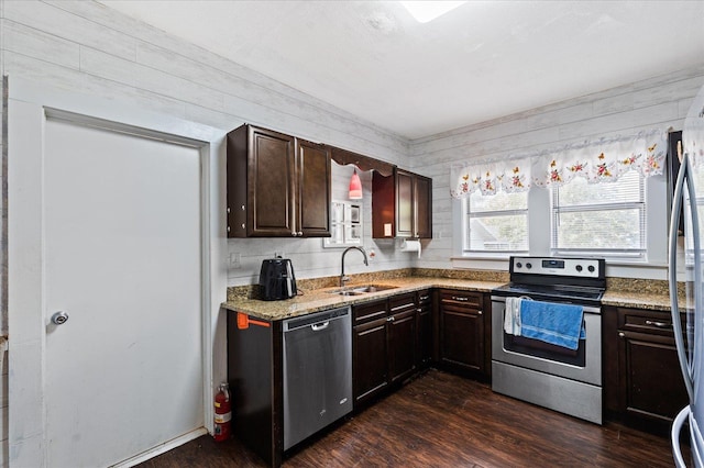 kitchen with dark brown cabinets, sink, stainless steel appliances, and dark hardwood / wood-style floors