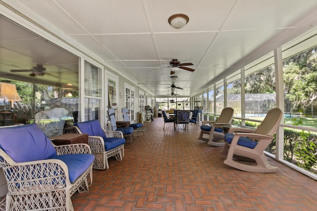 sunroom featuring plenty of natural light and ceiling fan