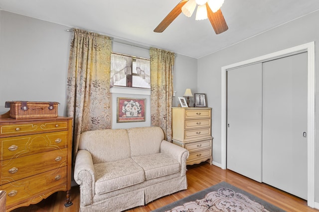 living area with light hardwood / wood-style flooring and ceiling fan