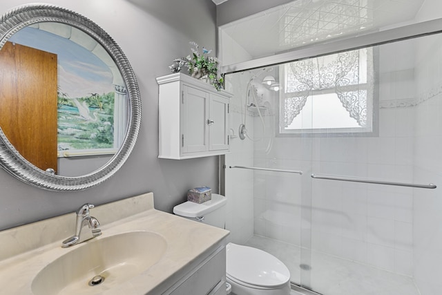 bathroom with vanity, a healthy amount of sunlight, toilet, and walk in shower