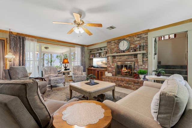 living room featuring a brick fireplace, ceiling fan, light tile patterned floors, and ornamental molding