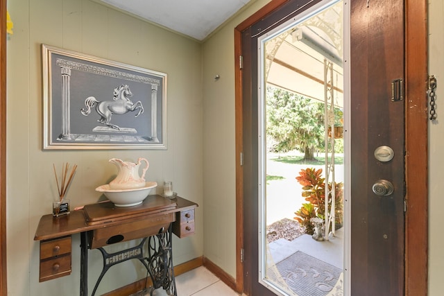 doorway to outside with light tile patterned flooring