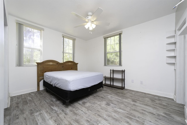 bedroom with hardwood / wood-style floors and ceiling fan