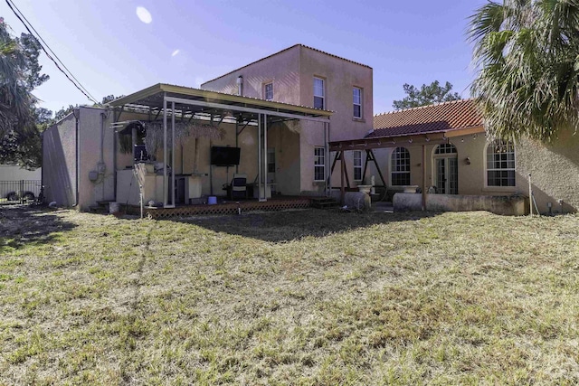 rear view of house featuring a yard