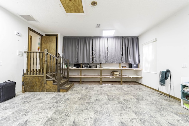 miscellaneous room with a textured ceiling