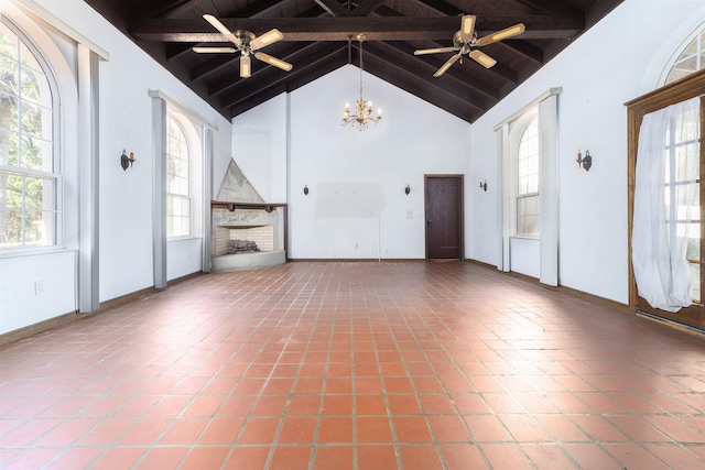 unfurnished living room with beam ceiling, high vaulted ceiling, and a wealth of natural light